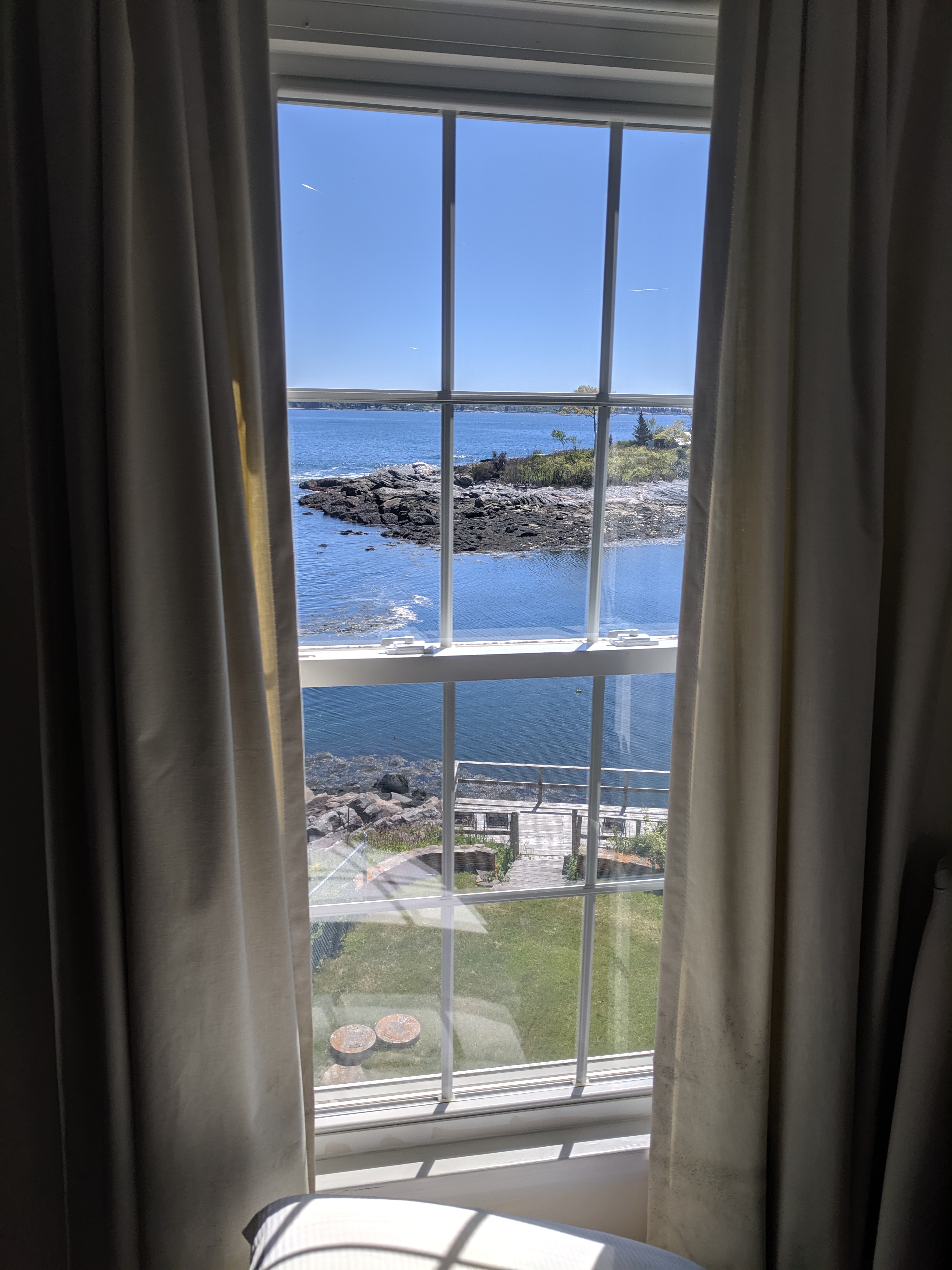 Decorative image of a sunny window opening on a rough ocean shore
